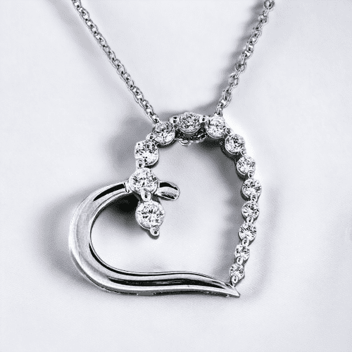 Cubic zirconia silver heart necklace on a white background.