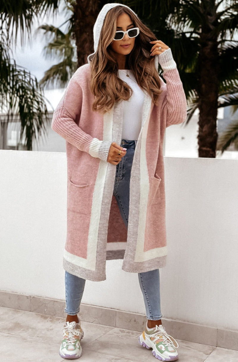 Women wearing a dusty pink colour block hooded cardigan with the hood up.