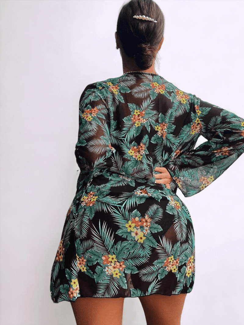 Rear view of a women wearing a Green Tropical 3 piece bikini set with long sleeved cover up.