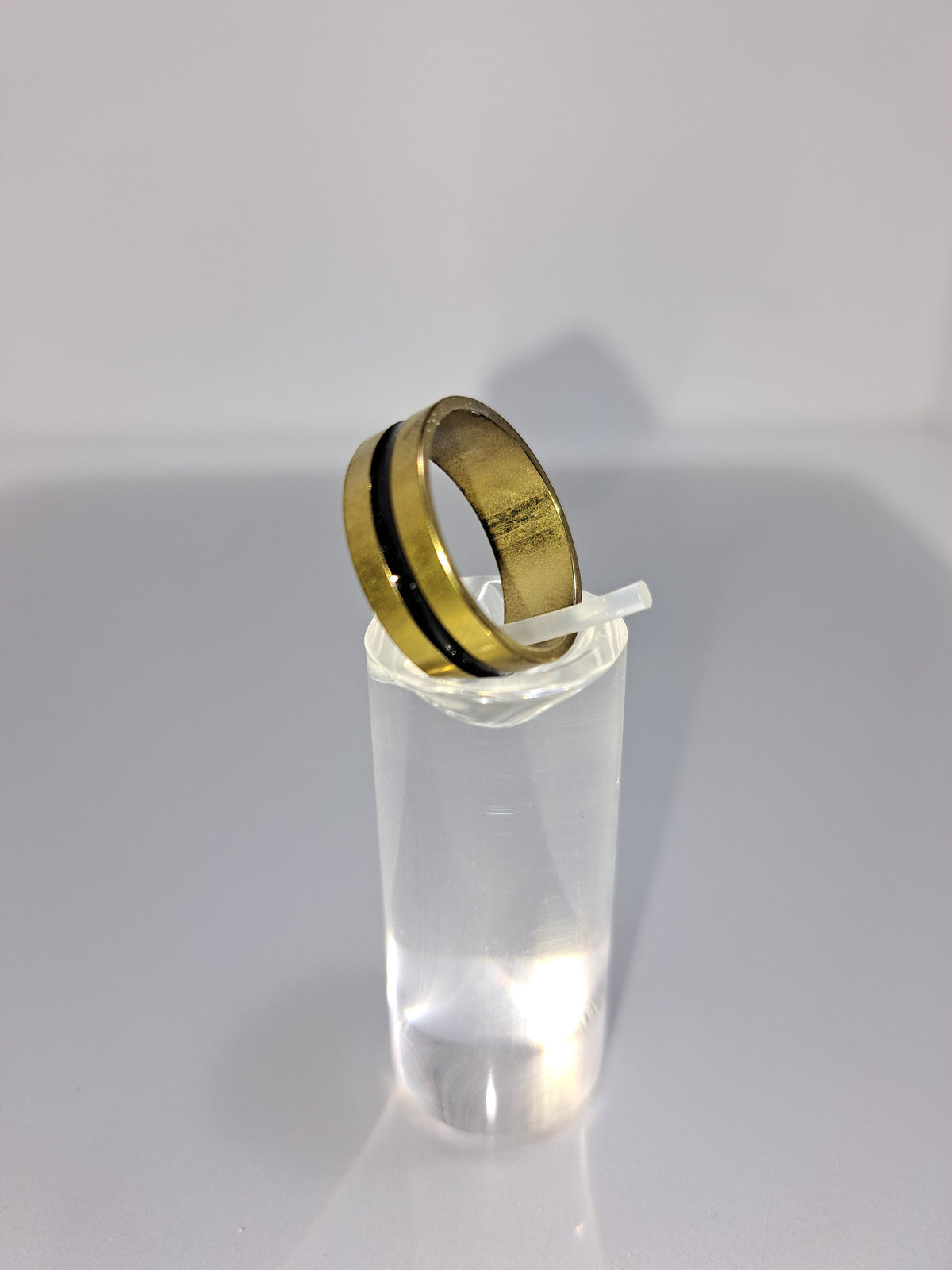 Gold stainless steel unisex ring with a black rounded channel around the band. Perfect costume jewellery.