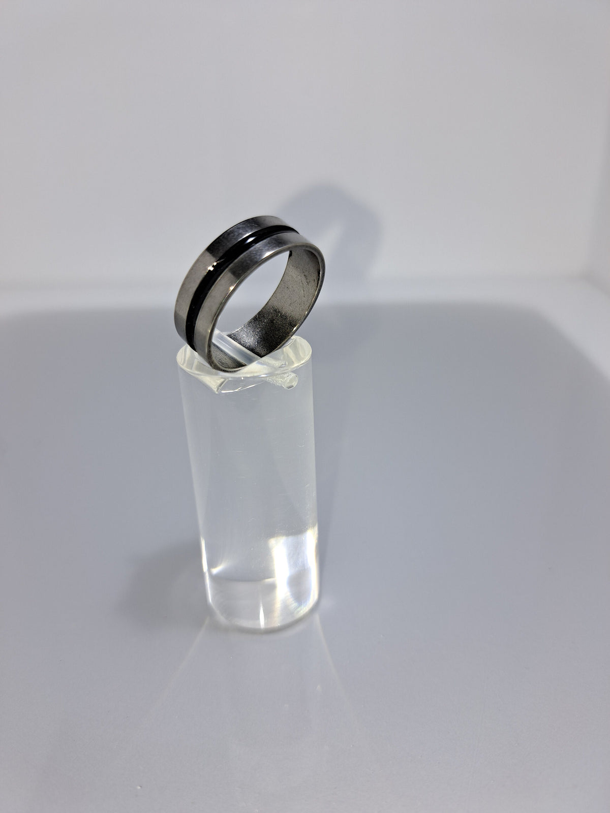 Silver stainless steel unisex ring with a black rounded channel around the band. Perfect costume jewellery.