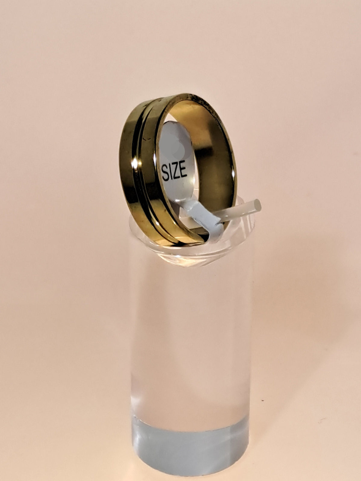 Gold stainless steel unisex ring with a rounded channel around the band. Perfect costume jewellery.